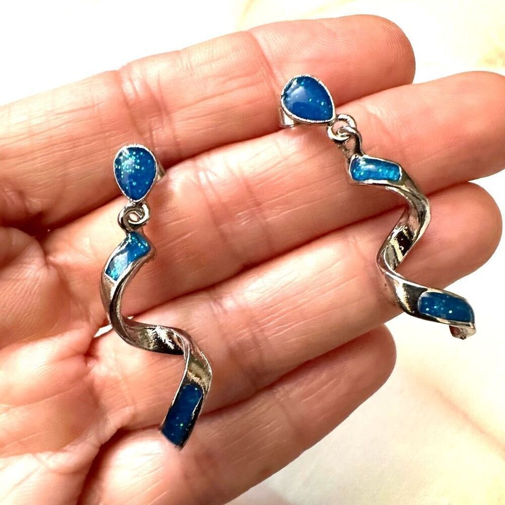Silver tone swirl blue inlay earrings